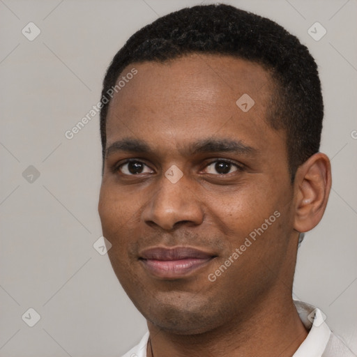 Joyful black young-adult male with short  black hair and brown eyes