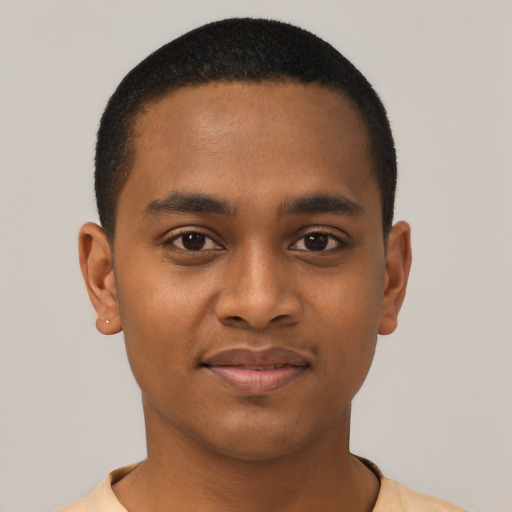 Joyful black young-adult male with short  black hair and brown eyes