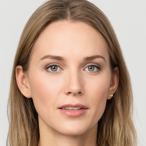 Joyful white young-adult female with long  brown hair and blue eyes