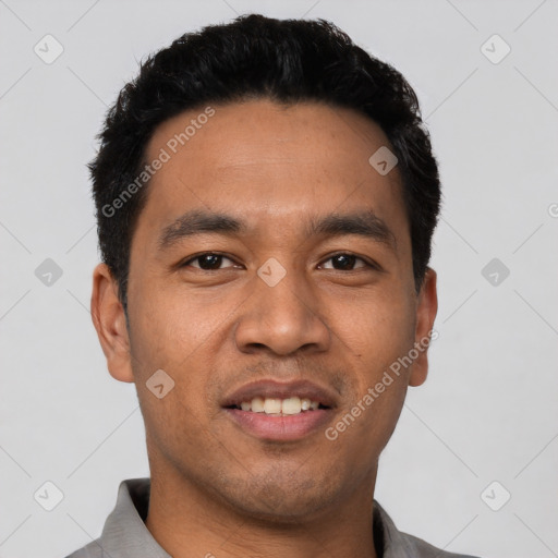 Joyful latino young-adult male with short  black hair and brown eyes