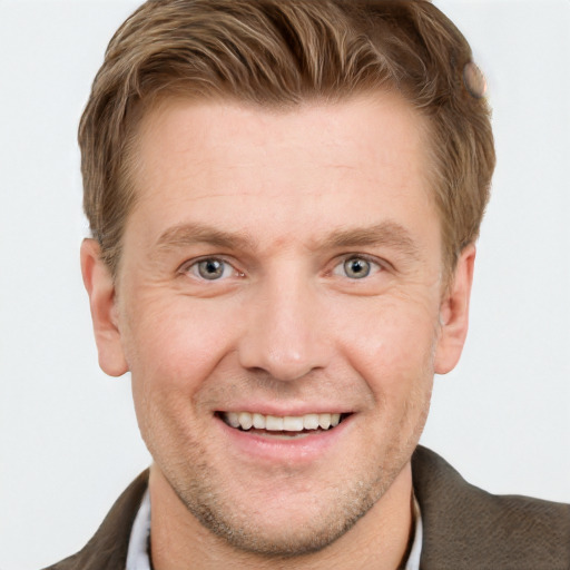 Joyful white adult male with short  brown hair and grey eyes