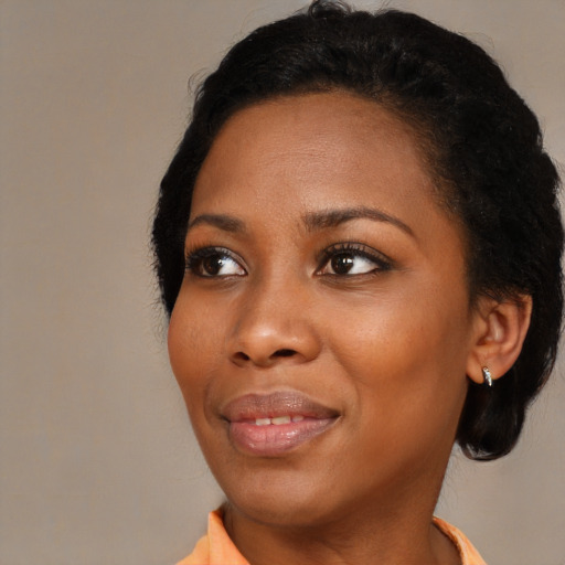 Joyful black young-adult female with medium  black hair and brown eyes