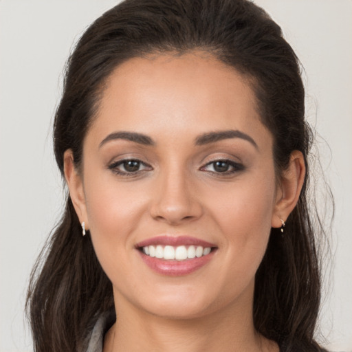 Joyful white young-adult female with long  brown hair and brown eyes