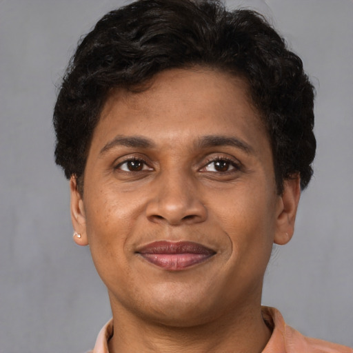 Joyful latino young-adult male with short  brown hair and brown eyes