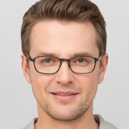 Joyful white adult male with short  brown hair and grey eyes