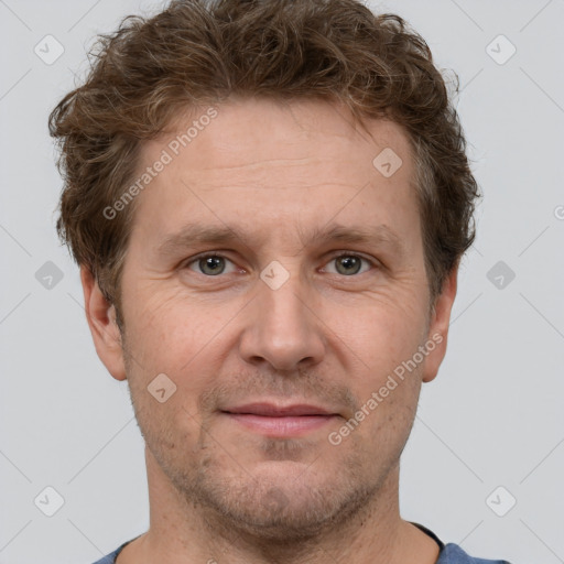 Joyful white adult male with short  brown hair and grey eyes