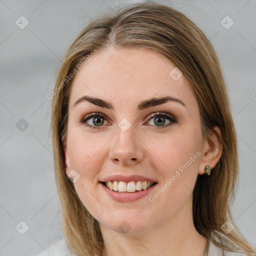 Joyful white young-adult female with medium  brown hair and blue eyes