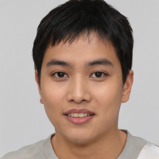 Joyful asian young-adult male with short  black hair and brown eyes