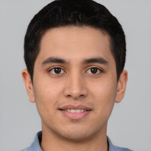 Joyful latino young-adult male with short  brown hair and brown eyes