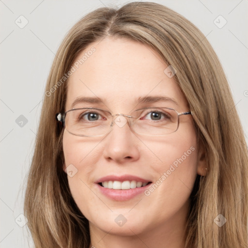 Joyful white young-adult female with long  brown hair and green eyes