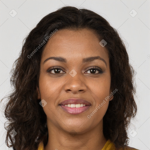 Joyful black young-adult female with long  brown hair and brown eyes