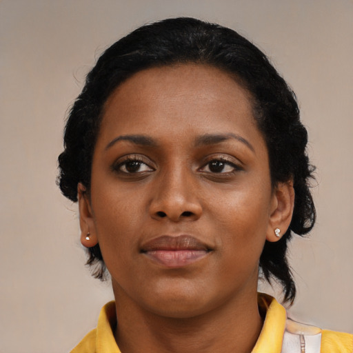 Joyful black young-adult female with medium  black hair and brown eyes