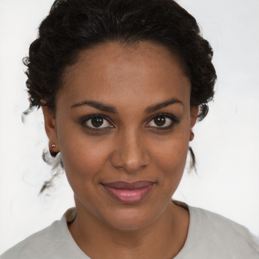 Joyful black young-adult female with short  brown hair and brown eyes