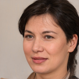 Joyful white adult female with medium  brown hair and brown eyes