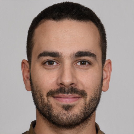 Joyful white young-adult male with short  brown hair and brown eyes