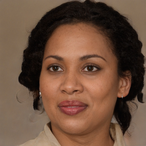 Joyful black adult female with medium  brown hair and brown eyes