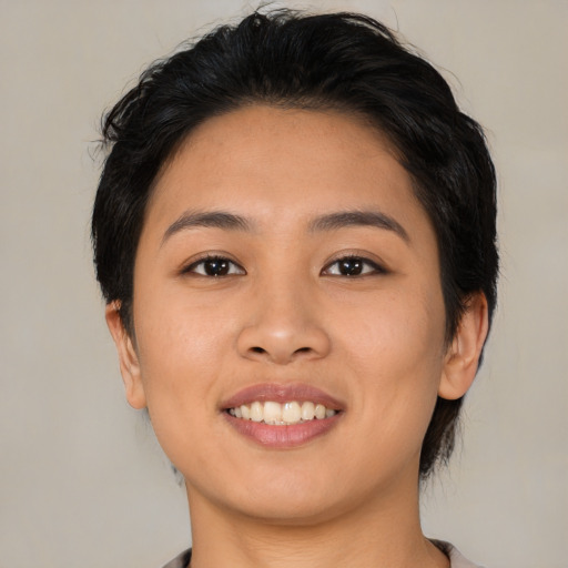 Joyful asian young-adult female with medium  black hair and brown eyes