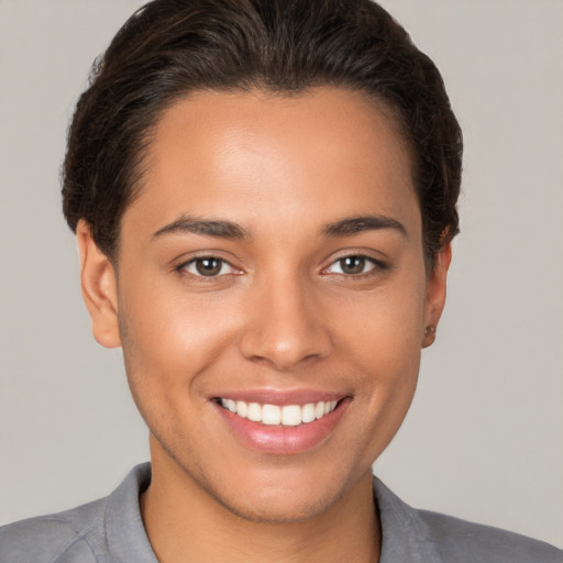 Joyful white young-adult female with short  brown hair and brown eyes