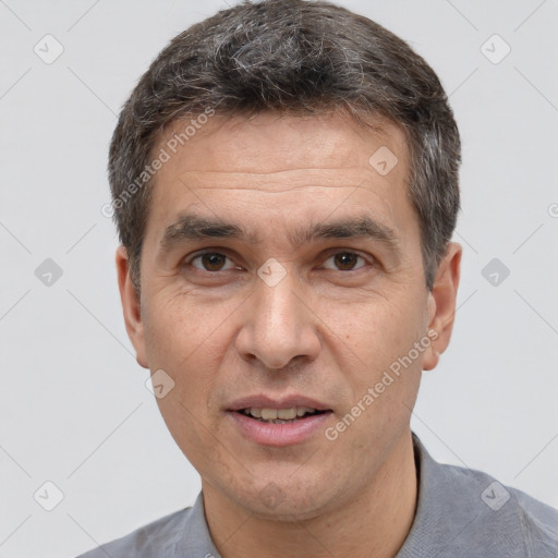 Joyful white adult male with short  brown hair and brown eyes