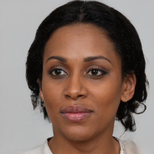 Joyful black young-adult female with medium  black hair and brown eyes
