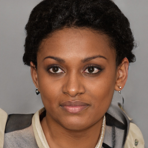 Joyful black young-adult female with short  brown hair and brown eyes