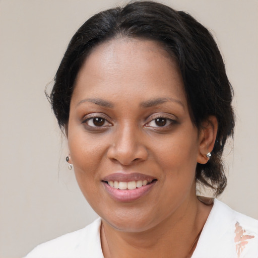 Joyful black young-adult female with medium  brown hair and brown eyes