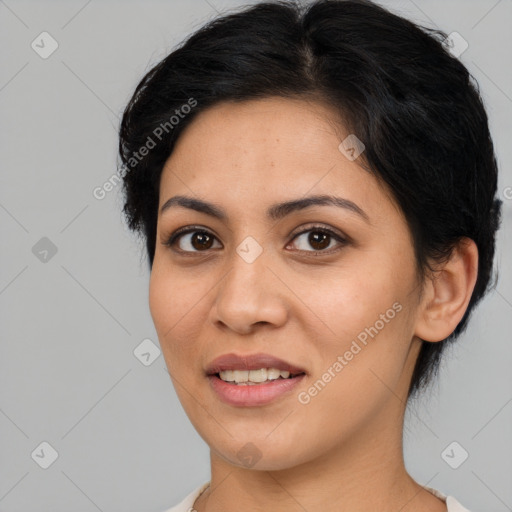 Joyful latino young-adult female with medium  brown hair and brown eyes