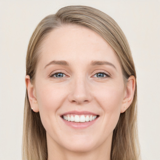 Joyful white young-adult female with long  brown hair and blue eyes