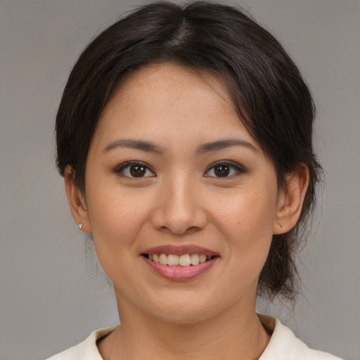 Joyful asian young-adult female with medium  brown hair and brown eyes