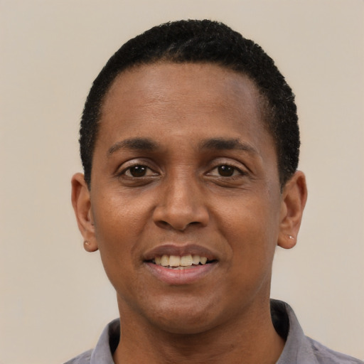 Joyful black young-adult male with short  black hair and brown eyes