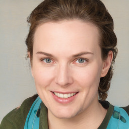 Joyful white young-adult female with medium  brown hair and green eyes