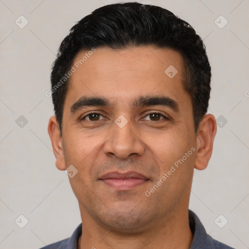 Joyful latino young-adult male with short  black hair and brown eyes