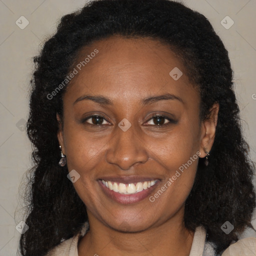 Joyful black young-adult female with long  brown hair and brown eyes