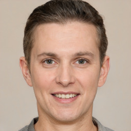 Joyful white adult male with short  brown hair and grey eyes