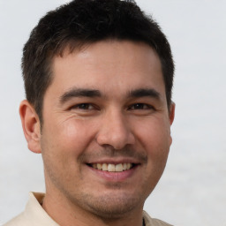 Joyful white young-adult male with short  brown hair and brown eyes