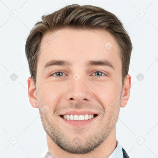 Joyful white young-adult male with short  brown hair and grey eyes