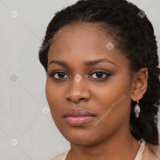 Joyful black young-adult female with long  brown hair and brown eyes