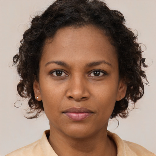 Neutral black young-adult female with medium  brown hair and brown eyes