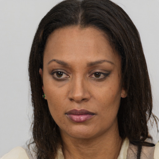 Neutral black adult female with long  brown hair and brown eyes