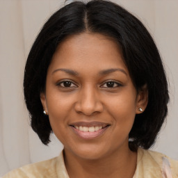 Joyful black young-adult female with medium  brown hair and brown eyes