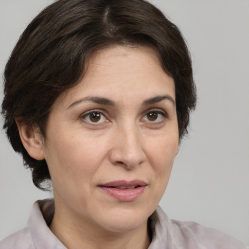 Joyful white adult female with medium  brown hair and brown eyes