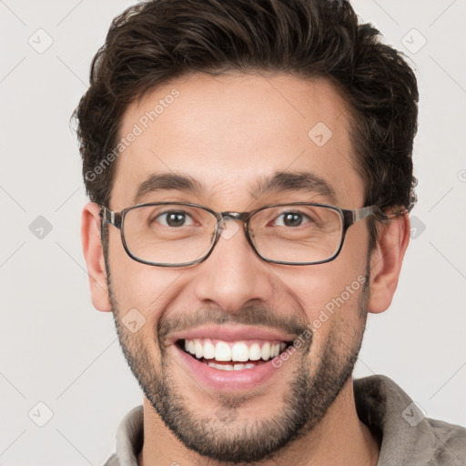 Joyful white young-adult male with short  brown hair and green eyes