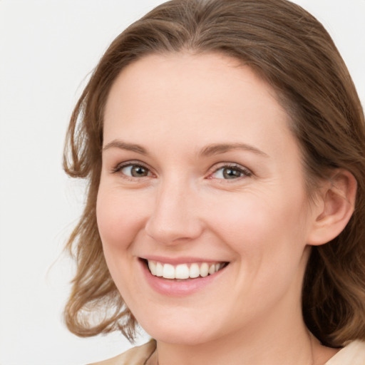 Joyful white young-adult female with medium  brown hair and blue eyes