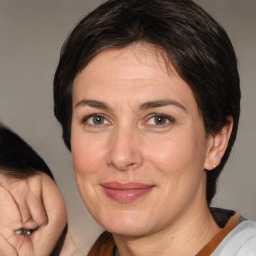 Joyful white adult female with medium  brown hair and brown eyes