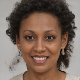 Joyful black adult female with medium  brown hair and brown eyes