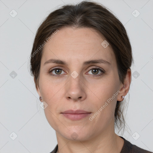 Joyful white adult female with medium  brown hair and grey eyes