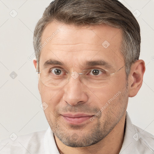 Joyful white adult male with short  brown hair and brown eyes