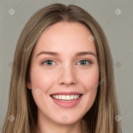 Joyful white young-adult female with long  brown hair and green eyes