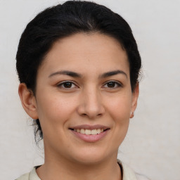 Joyful latino young-adult female with short  brown hair and brown eyes