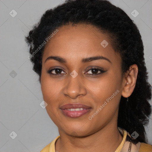 Joyful black young-adult female with long  black hair and brown eyes